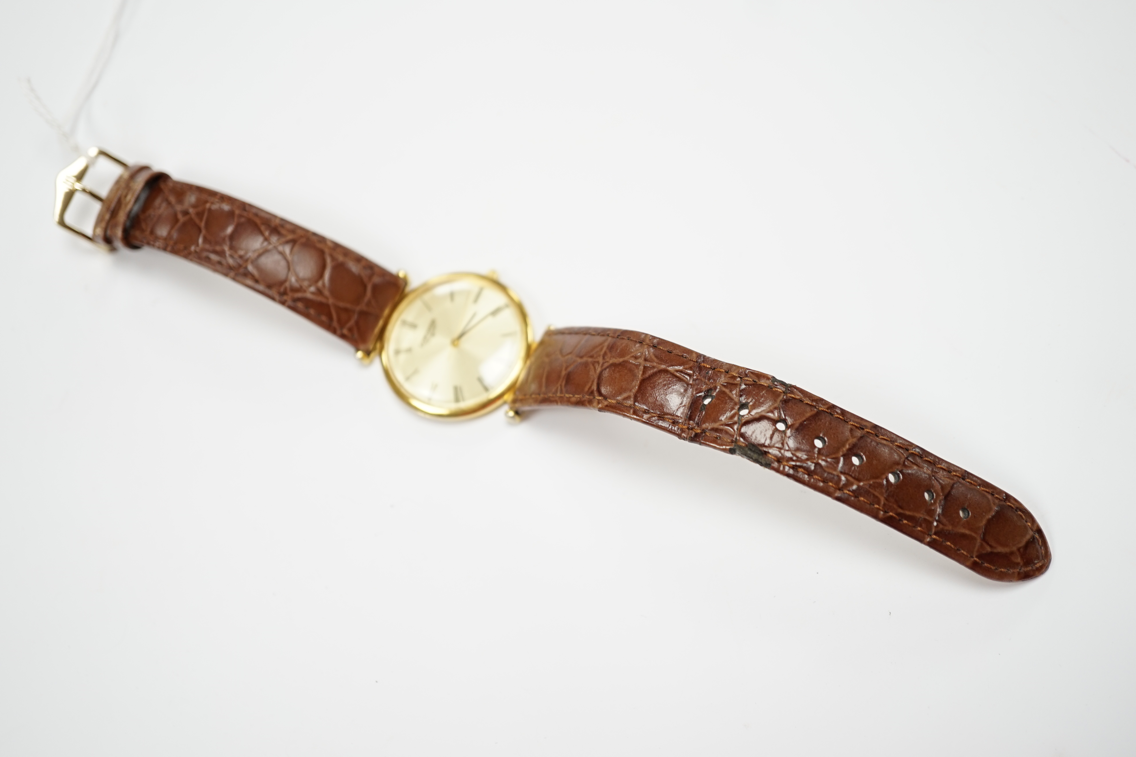 A gentleman's 24kt gold plated Longines quartz dress wrist watch, on associated leather strap.